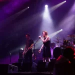 Slowdive performing on a purple-lit festival stage