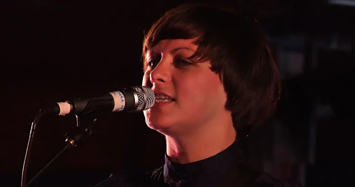 Tracyanne Campbell of Camera Obscura singing into a microphone
